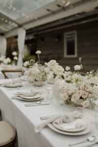 close-up view of the place settings and white floral centerpiece of the table